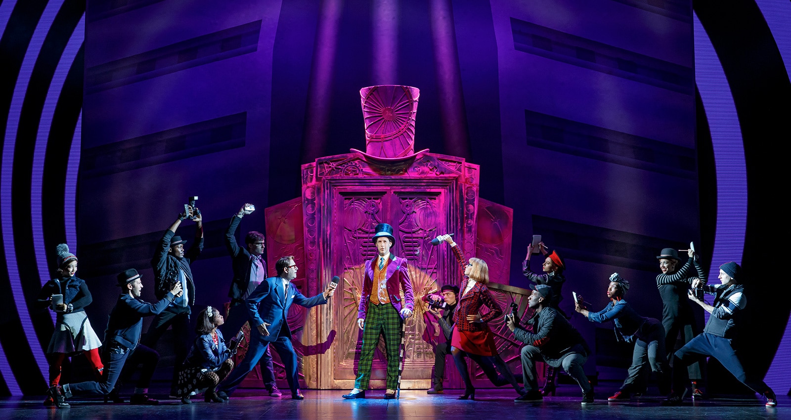 Noah Weisberg as Willy Wonka and company. Roald Dahl’s CHARLIE AND THE CHOCOLATE FACTORY. Photo by Joan Marcus-1600x850