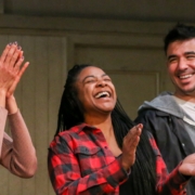 Four young adult actor stand in a row, smiling and clapping, at a DCPA Community Engagement event