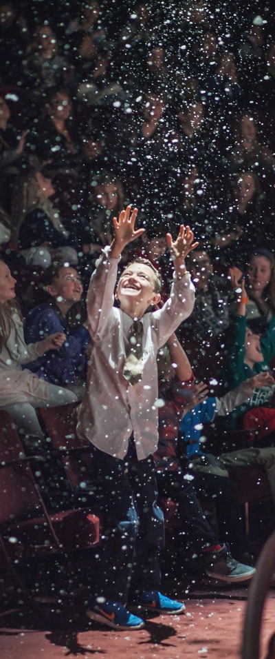 (Pictured at right: A student enjoys the snowy finale of 'A Christmas Carol' in the Stage Theatre in 2016. Photo by Amanda Tipton.)