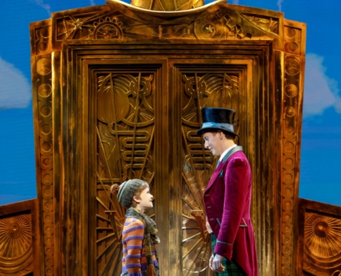 Henry Boshart as Charlie Bucket and Noah Weisberg as Willy Wonka. Roald Dahl’s CHARLIE AND THE CHOCOLATE FACTORY. Photo by Joan Marcus.