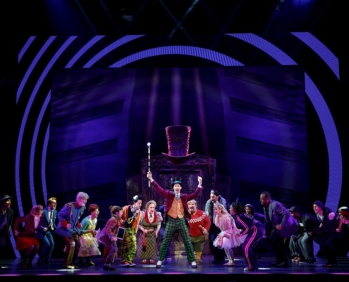 Noah Weisberg as Willy Wonka and company. Roald Dahl’s CHARLIE AND THE CHOCOLATE FACTORY. Photo by Joan Marcus