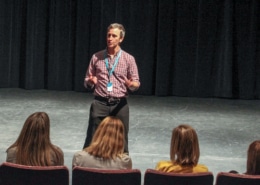Timothy McCracken Teaching Artist standing on stage addressing an audience