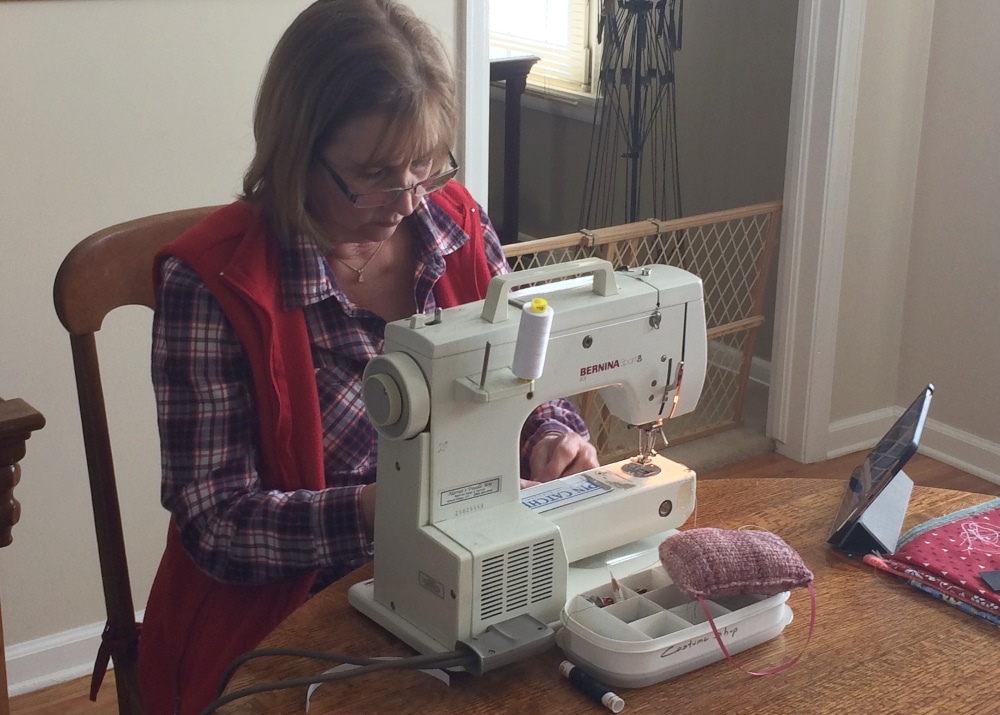 Jan MacLeod sews one of the first masks from DCPA fabric strips. Photo by Charles MacLeod.