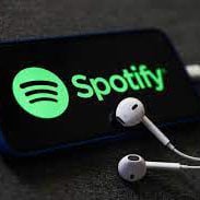 The spotify logo on an iPhone with headphones