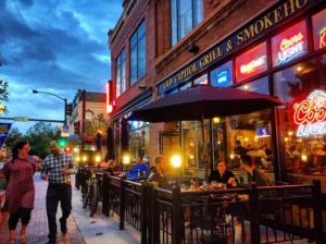 The Old Capitol Grill & Smokehouse. Image shows the outside eating area located in front of the pub