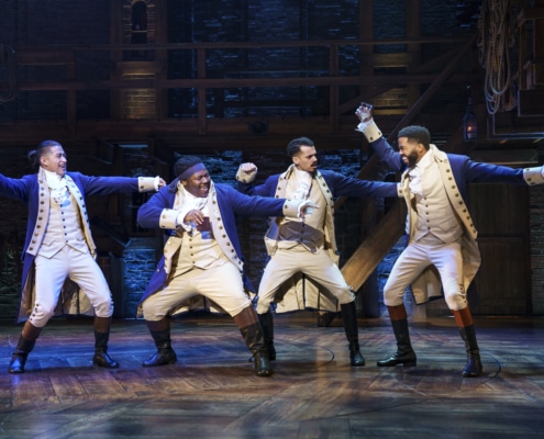 Cast of Hamilton Broadway National Tour dances in a line onstage