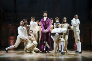 Thomas Jefferson stands surrounded by dancers onstage looking out to the audience in Hamilton Broadway National Tour