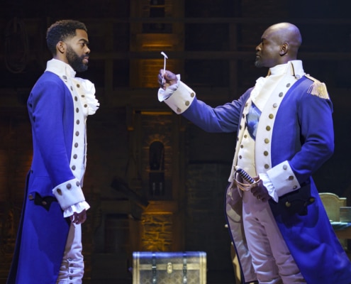 Alexander Hamilton stands with George Washington onstage in Hamilton Broadway National Tour