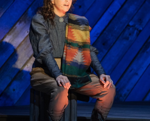 Neyla Pekarek appears on stage in Western garb as she portrays Brownie during a performance of Rattlesnake Kate