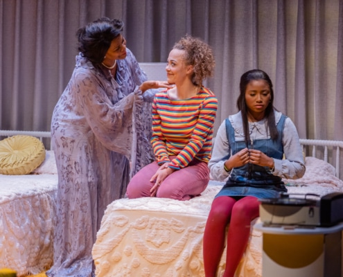 Chavez Ravine, Kayla King, and Courtney A. Vinson appear on a set designed to look like a girl’s bedroom in the 1970s