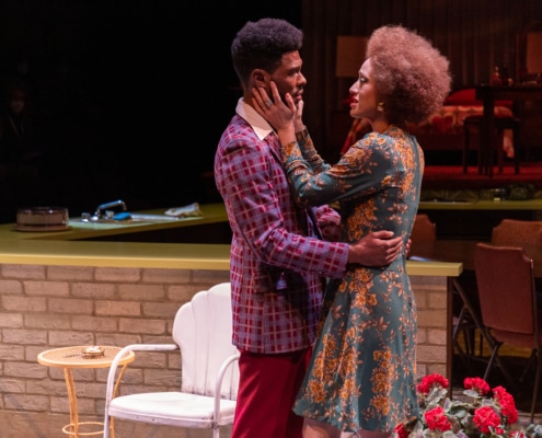 Matthew Hancock and Sydney Cole Alexander embrace on stage during a performance of In the Upper Room at the Denver Center