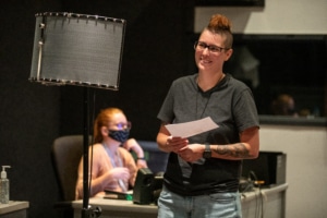 A student in a DCPA Voice Over class smiles while holding a script