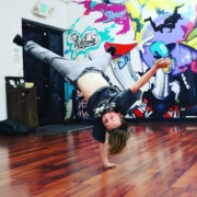 a young dancer does a handstand trick