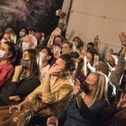 Audience sits watching a show at the Local Theater Company