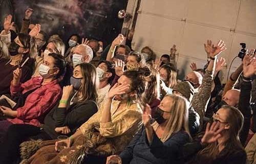 Audience sits watching a show at the Local Theater Company