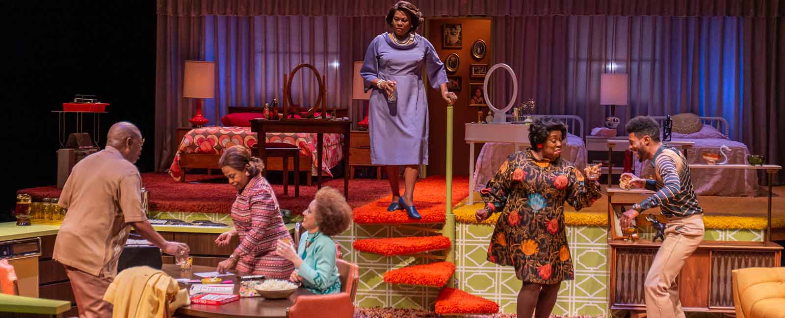 The cast of In The Upper Room — some dancing, some gathered around a table — appear on stage at the Denver Center