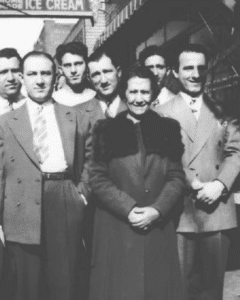 Black and white photo of a family surrounding their mother