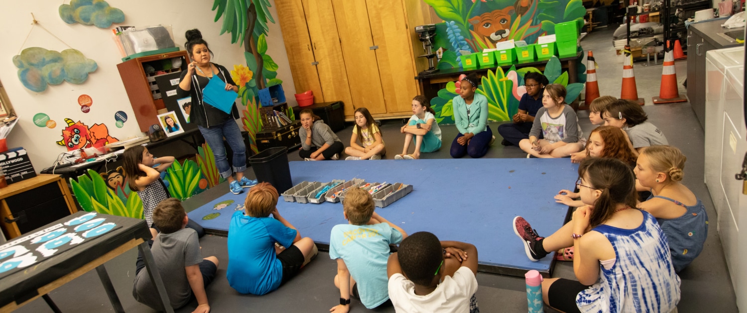 DCPA Teaching Artist Rachel Taylor leads a Book Stars workshop with elementary age students