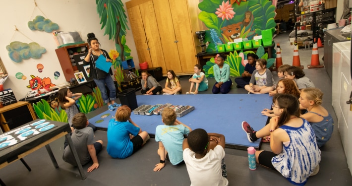 DCPA Teaching Artist Rachel Taylor leads a Book Stars workshop with elementary age students