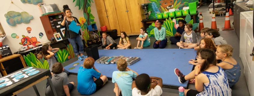 DCPA Teaching Artist Rachel Taylor leads a Book Stars workshop with elementary age students