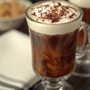 An irish coffee in a handled glass with chocolate shavings on top