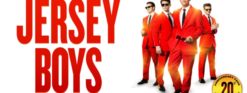 Promotional graphic for Jersey Boys featuring four performers in matching bright red suits and black ties against a white background. Large red text displays the show's title, while smaller text above and below notes the return of the Tony Award-winning musical. A gold emblem in the corner highlights the 20th anniversary tour.