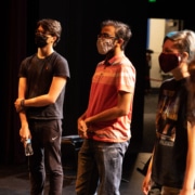 Students stand in a circle onstage in the Weeks Conservatory Theatre