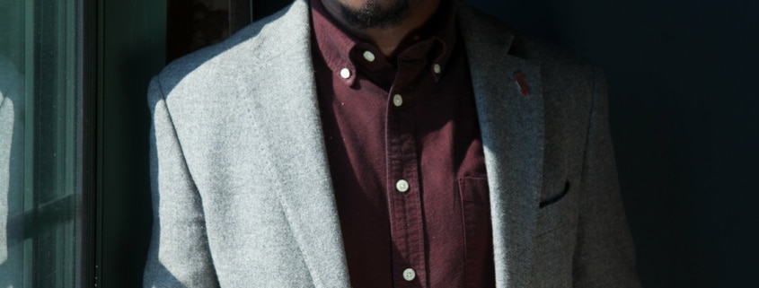 Jamil Jude wearing a suit in a dark room