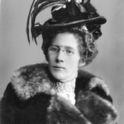 An old photograph of Jennie Rogers wearing a feathered hat and fur coat