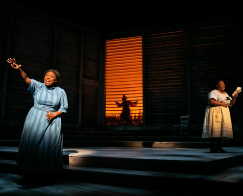 On the left, a woman sings with one arm outstretched, reaching for something we can't see. On the right, a woman sings while reading a letter.