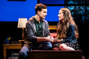 Stephen Christopher Anthony as Evan Hansen and Stephanie La Rochelle as Zoe Murphy sit on a couch together