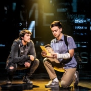 Noah Kieserman as Connor Murphy and Stephen Christopher Anthony as Evan Hansen kneel onstage