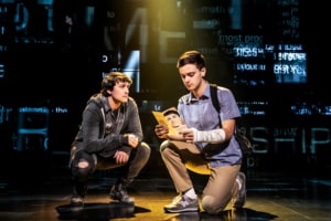 Noah Kieserman as Connor Murphy and Stephen Christopher Anthony as Evan Hansen kneel onstage