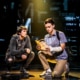 Noah Kieserman as Connor Murphy and Stephen Christopher Anthony as Evan Hansen kneel onstage