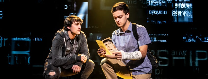 Noah Kieserman as Connor Murphy and Stephen Christopher Anthony as Evan Hansen kneel onstage