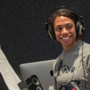 An actor in a DCPA Education voice over class wears headphones and smiles