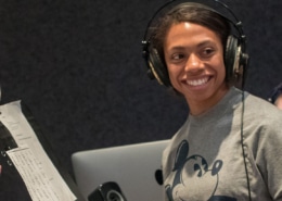 An actor in a DCPA Education voice over class wears headphones and smiles