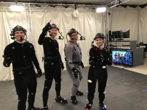 A group of actors wearing MoCap Suits pose for a photo