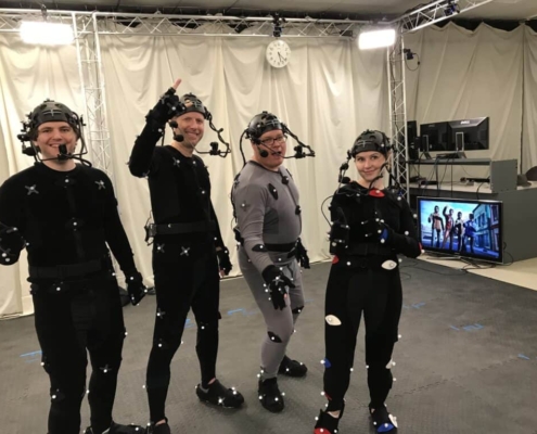 A group of actors wearing MoCap Suits pose for a photo