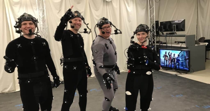 A group of actors wearing MoCap Suits pose for a photo