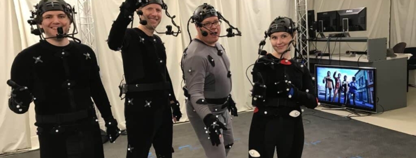 A group of actors wearing MoCap Suits pose for a photo