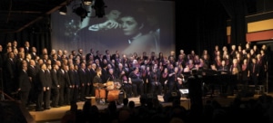 The Denver Gay Men's and Women's Chorus sings onstage at their StoneWall performance