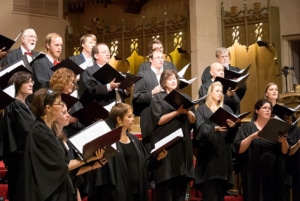 St. Martin's Chamber Choir sings from music books onstage