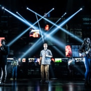 Evan Hansen surrounded by lights and screens in Dear Evan Hansen