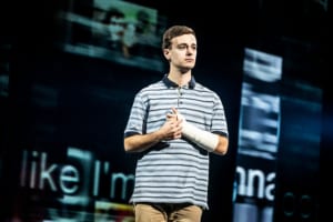 Evan Hansen holds his arm cast close to his chest in Dear Evan Hansen