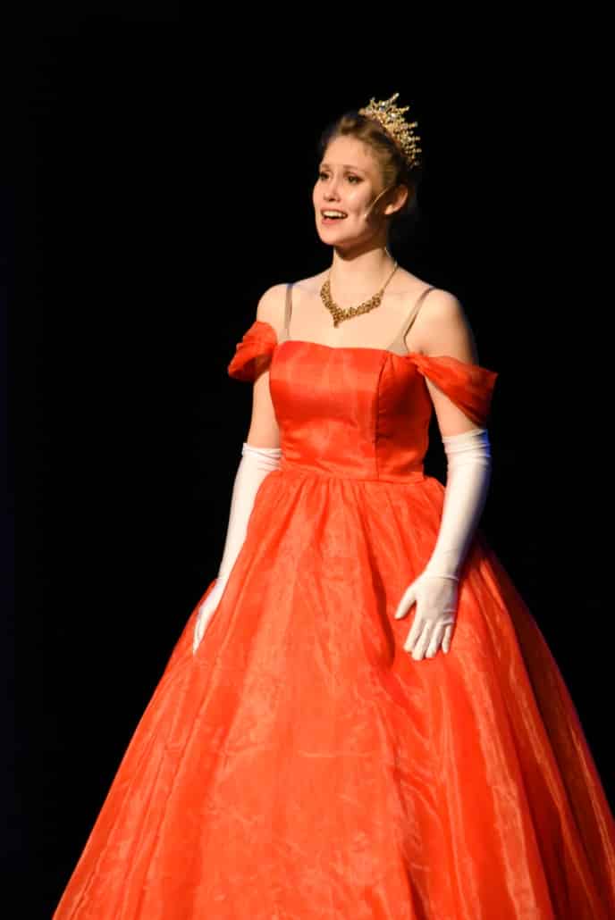 Morgan Fritzler onstage wearing a bright princess gown