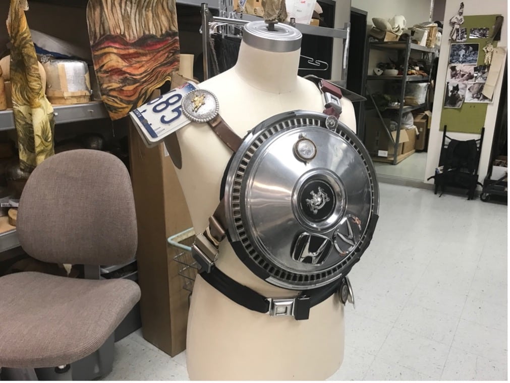 A metal armor plate is strapped to a mannequin