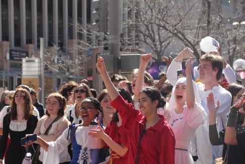 Students cheer in a large crowd