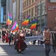 A group of students march down the street dressed in Renaissance clothing