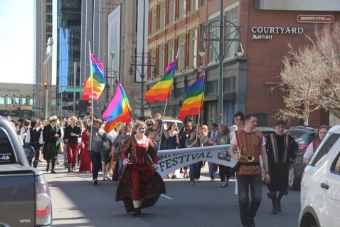 A group of students march down the street dressed in Renaissance clothing